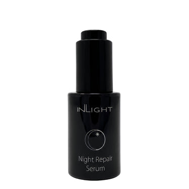 A black cylindrical bottle of INLIGHT Night Repair Serum with a matching black cap, set against a plain white background.