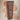 Tube of Innersense Inner Glow Body Scrub with swatch of peach coloured scrub behind it