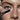 Model holding the brush of Madara Bold Volume Mascara and applying it to the eye lashes