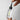 Bottle of Madara Scalp Peel Serum held between model's hands against grey background