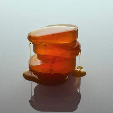 Abel Warm Natural Perfume Layering Duo stack of amber on blue background