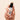 Model's hand holding an open Madara Mineral SPF50 Stick