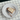 Mirror Water Butter Brick on top of a piece of sourdough sitting on a white plate with a butter knife