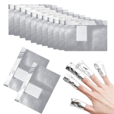 A set of metallic silver nail wraps shown in a stack, with two individual wraps displayed and one hand wearing several wrapped fingers on a plain white background.