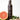 Bottle of John Masters Daily Nourishing Shampoo With Citrus & Geranium with plants in background