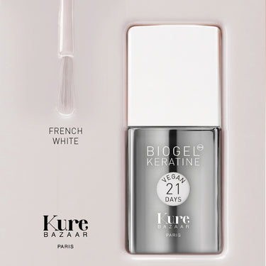 Kure Bazaar Biogel Keratine vegan 21 days nail polish in the shade French White, shown in a silver bottle with a white cap next to its applicator brush on a light beige background.